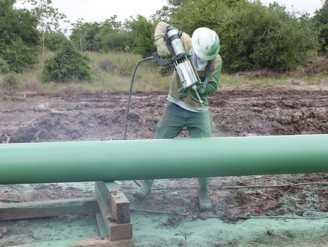 A Protal cartridge being used to repair a damaged pipe coating section