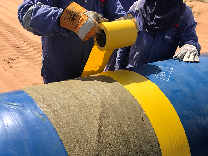 Denso PVC Self-Adhesive Tape protective outerwrap being applied
